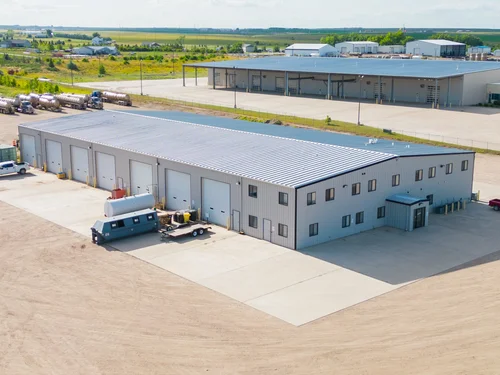 Industrial real estate broker reviewing Bakken site maps and selecting property location for energy operations