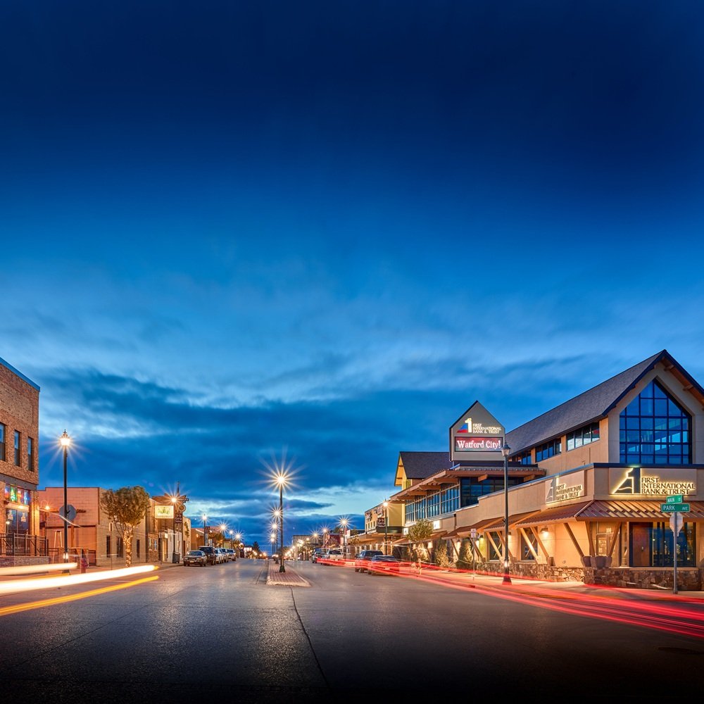 Industrial client touring fenced yard and shop property with broker in Bakken market